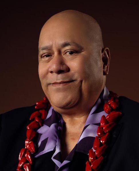 potrait of Pati Umaga, wearing a red lei around his neck